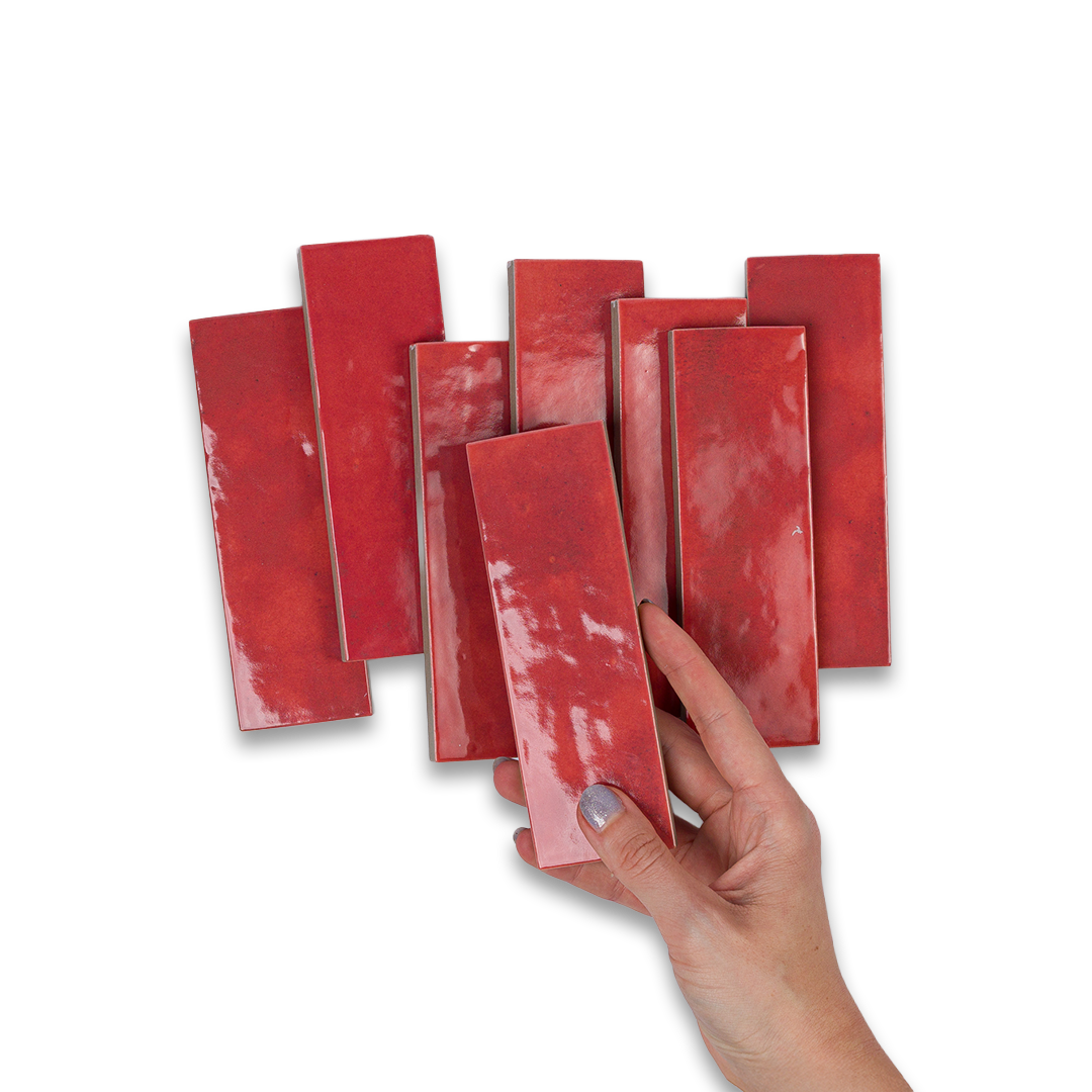 Hand holding a red rectangular object against a white background