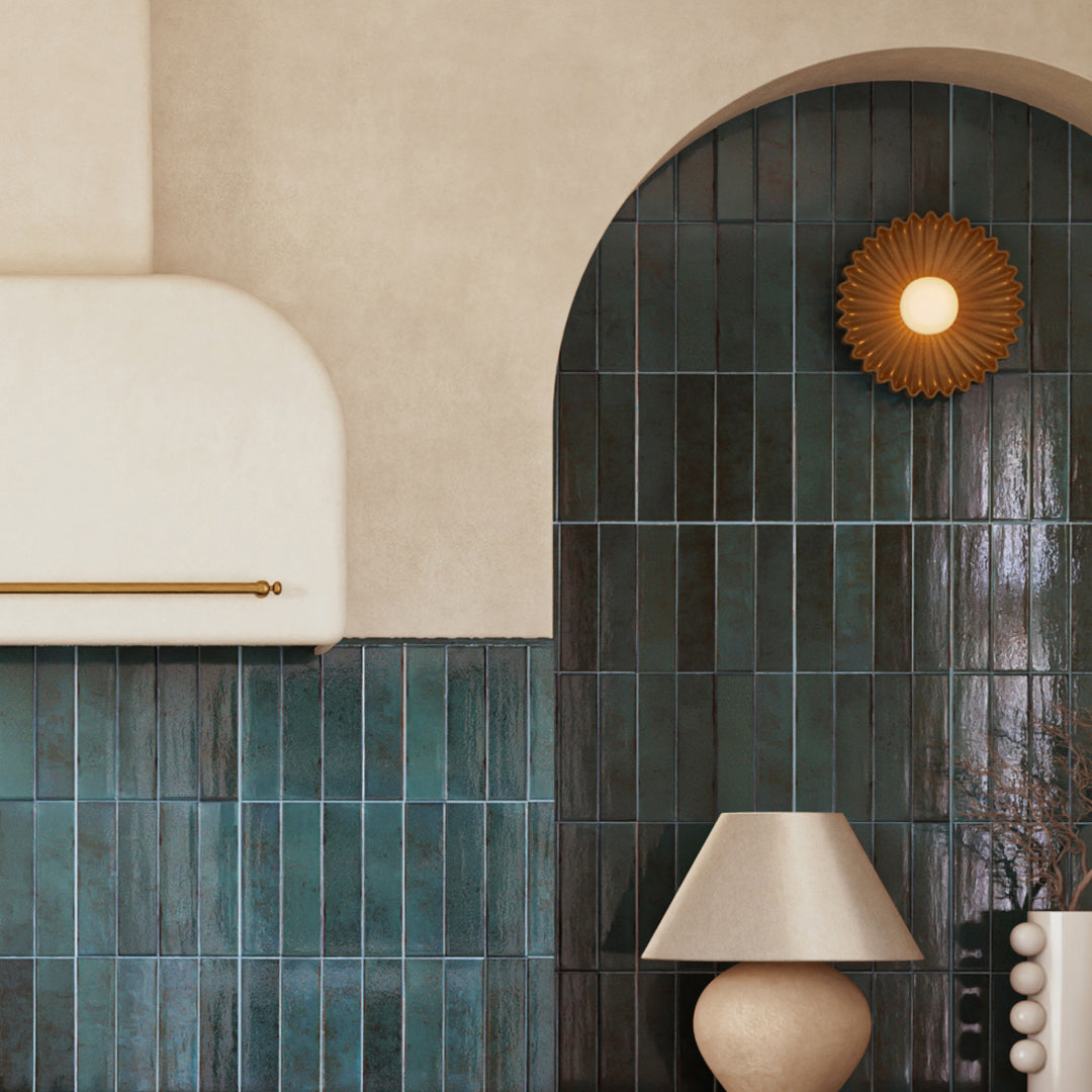 Decorative interior with green tiles, a beige lamp, and a wall light fixture.