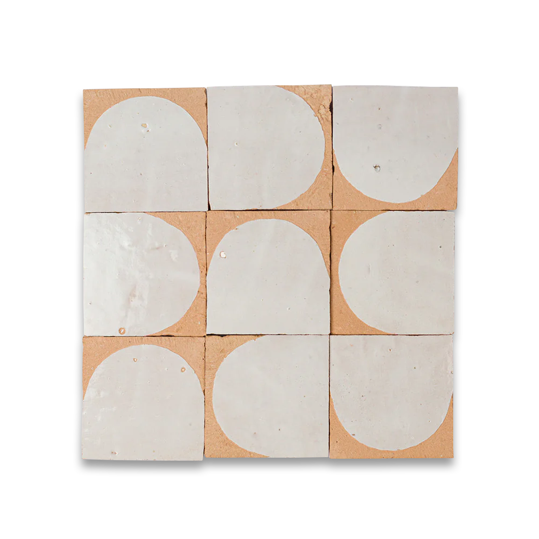 Set of ceramic tiles with half-circle designs on a cardboard backing