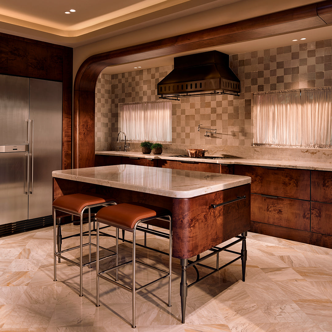 Modern kitchen with marble island, stainless steel appliances, and wooden cabinets.
