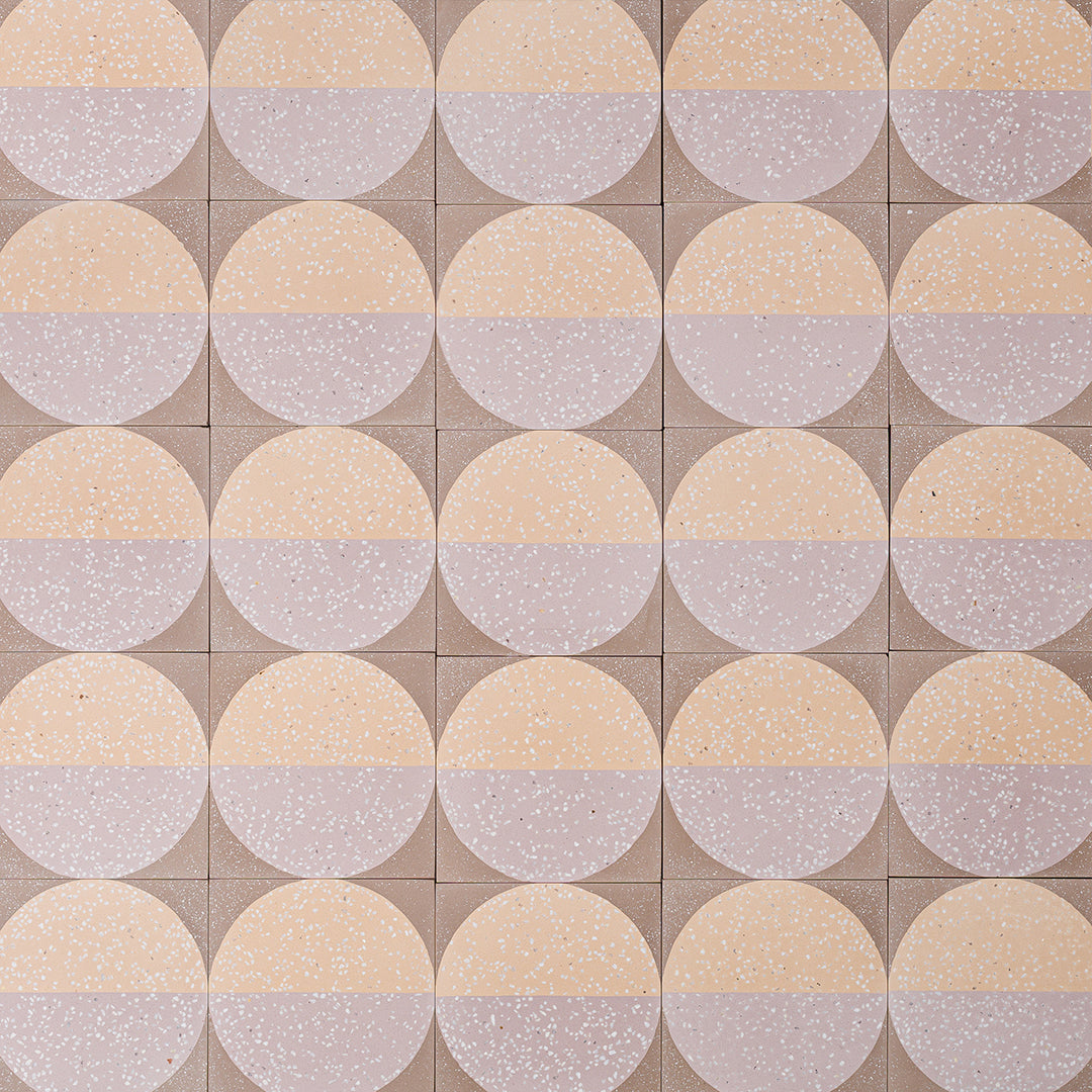 A large circular pattern in peach and lavender tones with speckled texture, ideal for contemporary flooring or wall decor.