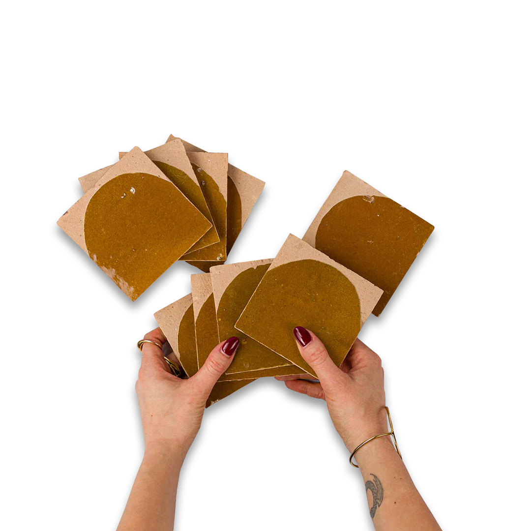 Hands holding brown cardboard circles on a white background