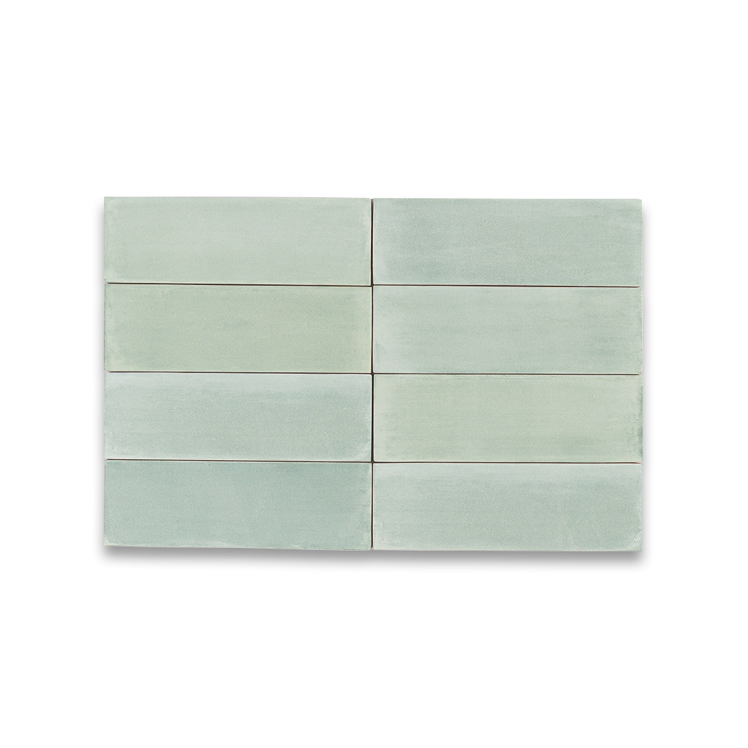 Set of six green ceramic tiles on a white background