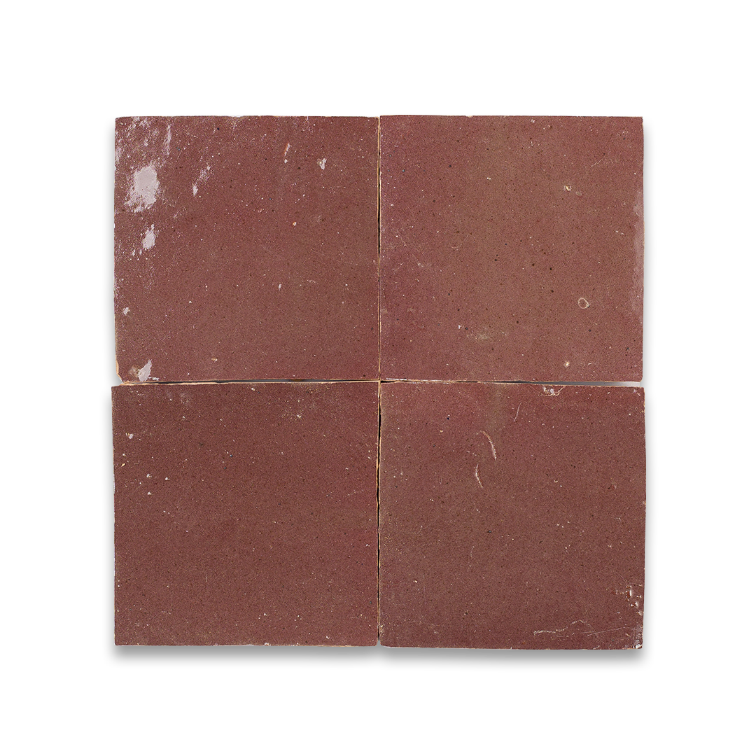 Four square tiles with a reddish-brown color on a white background