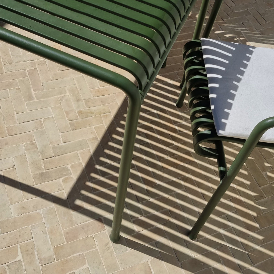 Green metal chair on a stone patio