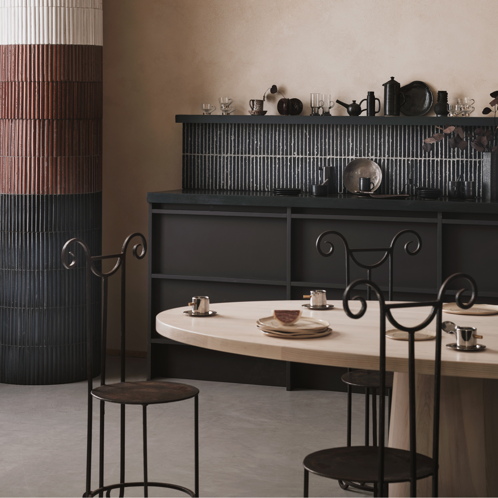 Dining area with a round table and chairs in a modern kitchen setting.