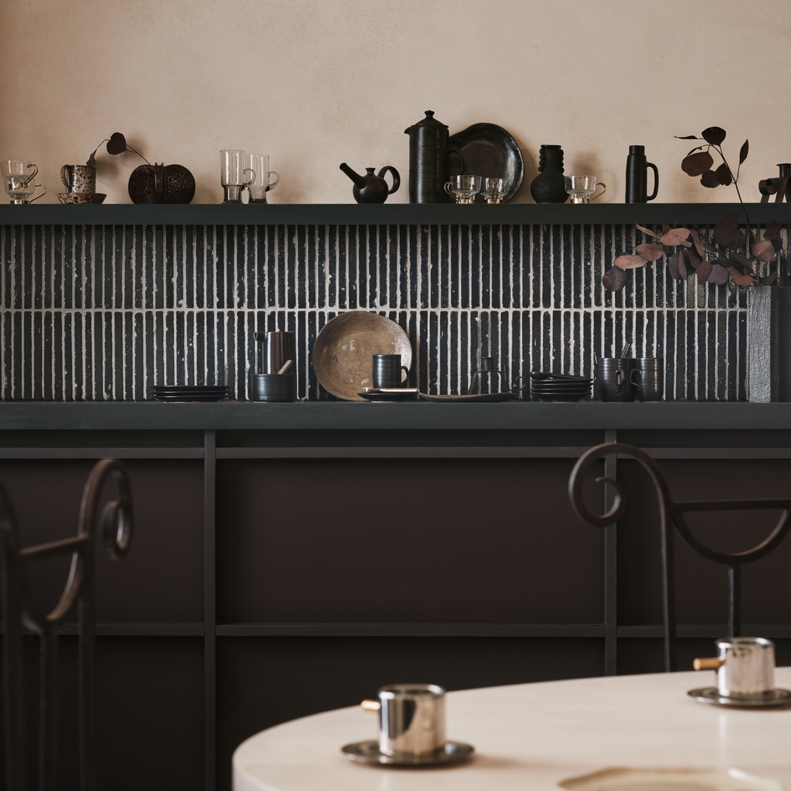 Modern kitchen with black shelving unit and marble countertop