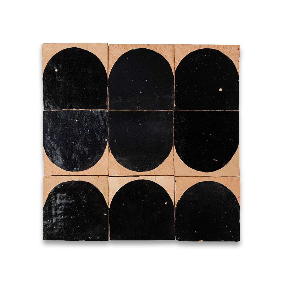 Black oval-patterned tiles on a cardboard backing