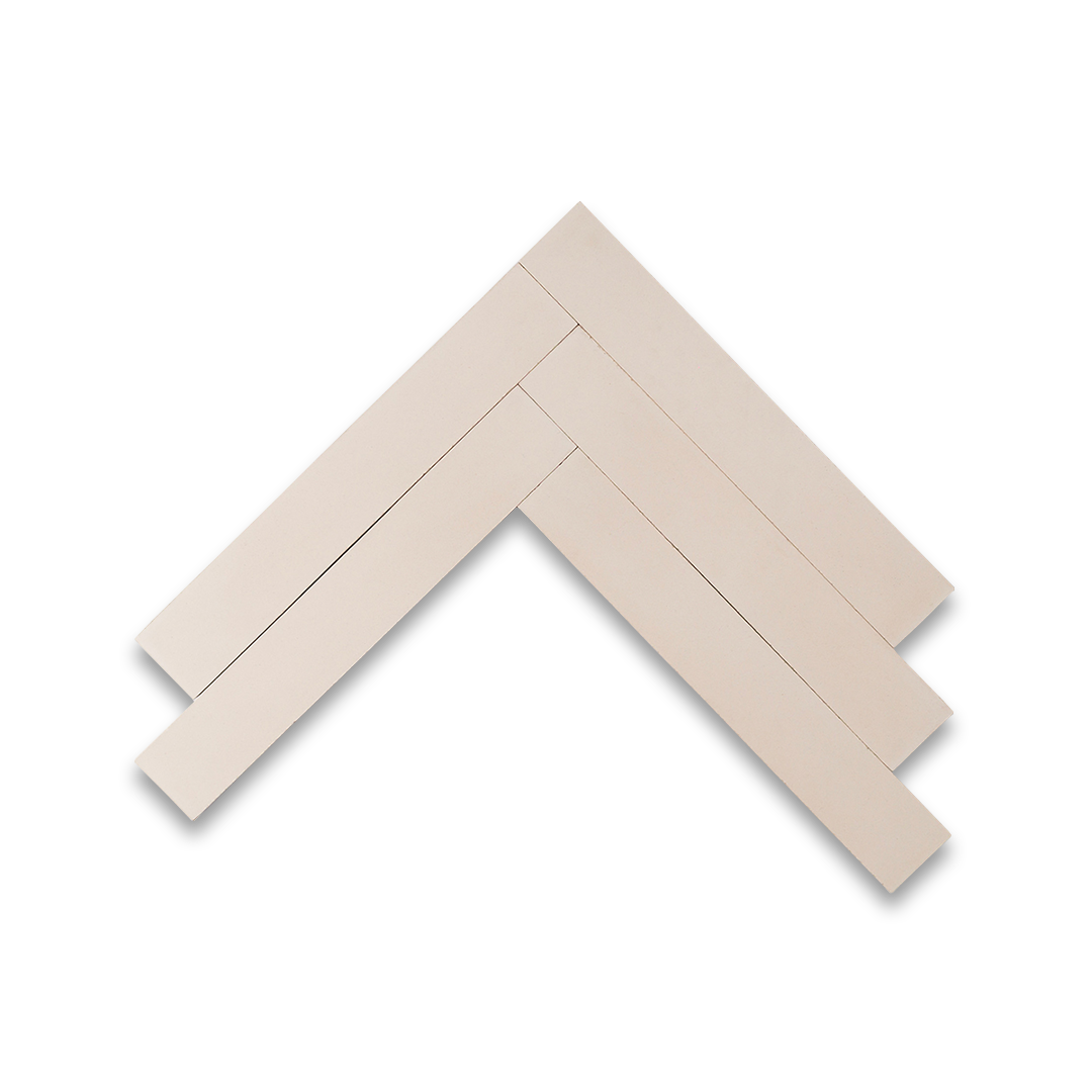 Cream-toned rectangular cement tiles arranged in a herringbone pattern, showcasing a smooth matte finish, ideal for modern interiors, minimalist flooring, and wall applications in contemporary spaces.