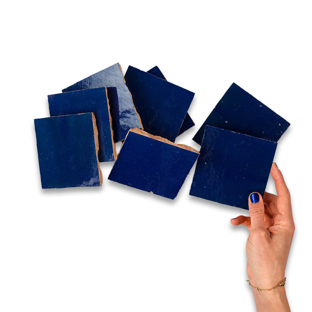 Set of blue square tiles with a hand holding one tile on a white background