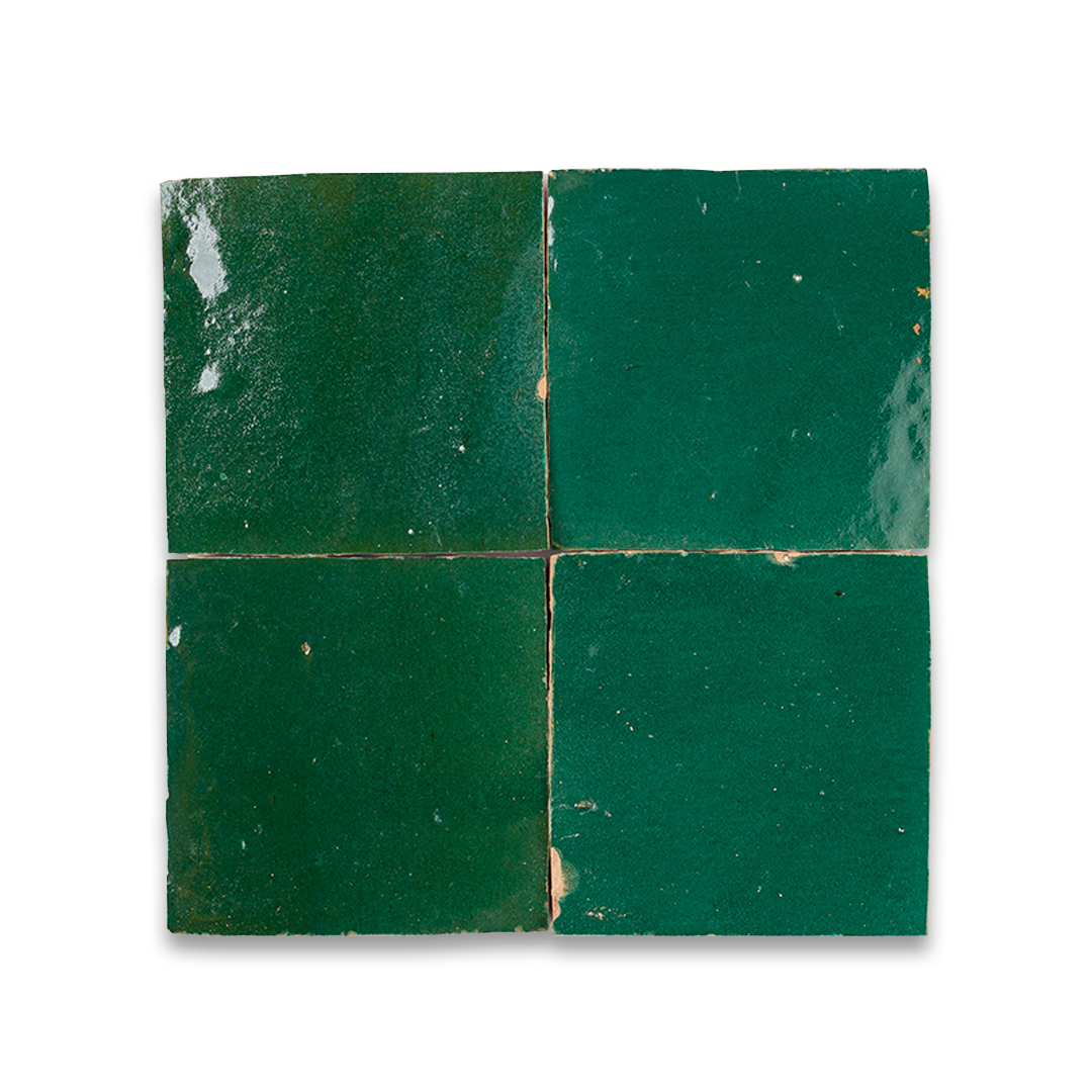 Four green tiles on a white background