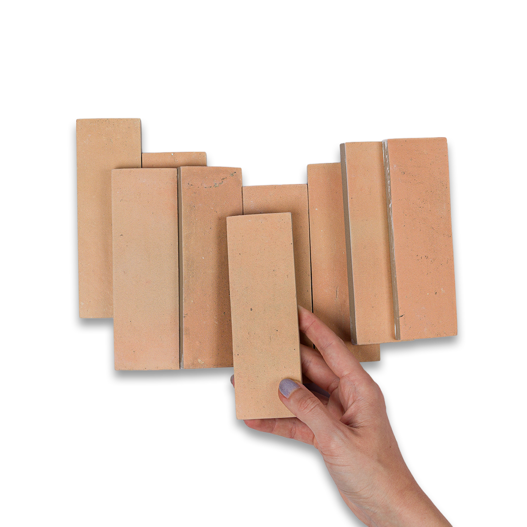 Set of cardboard boxes with a hand holding one of them on a white background