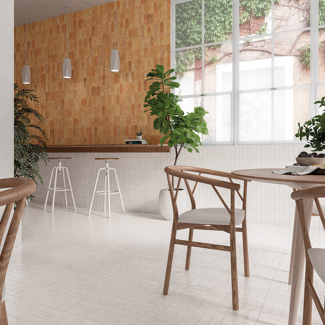 Modern kitchen with wooden cabinets, white stools, and a dining table.