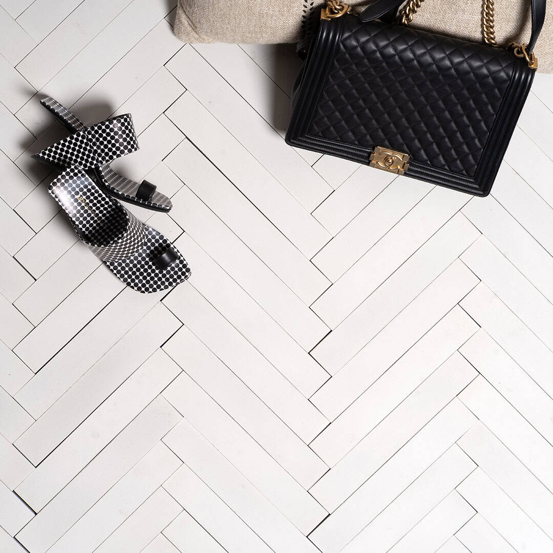 Polar Weave cement tile featuring a matte white herringbone pattern with clean linear texture, ideal for modern interiors, minimalist flooring, and wall applications in contemporary architectural spaces.