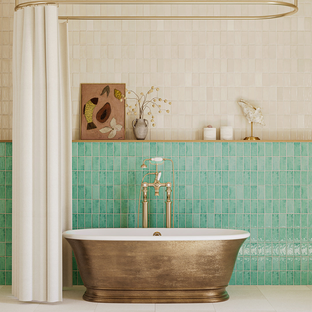Bathroom with a bronze bathtub, green tiled wall, and decorative elements.