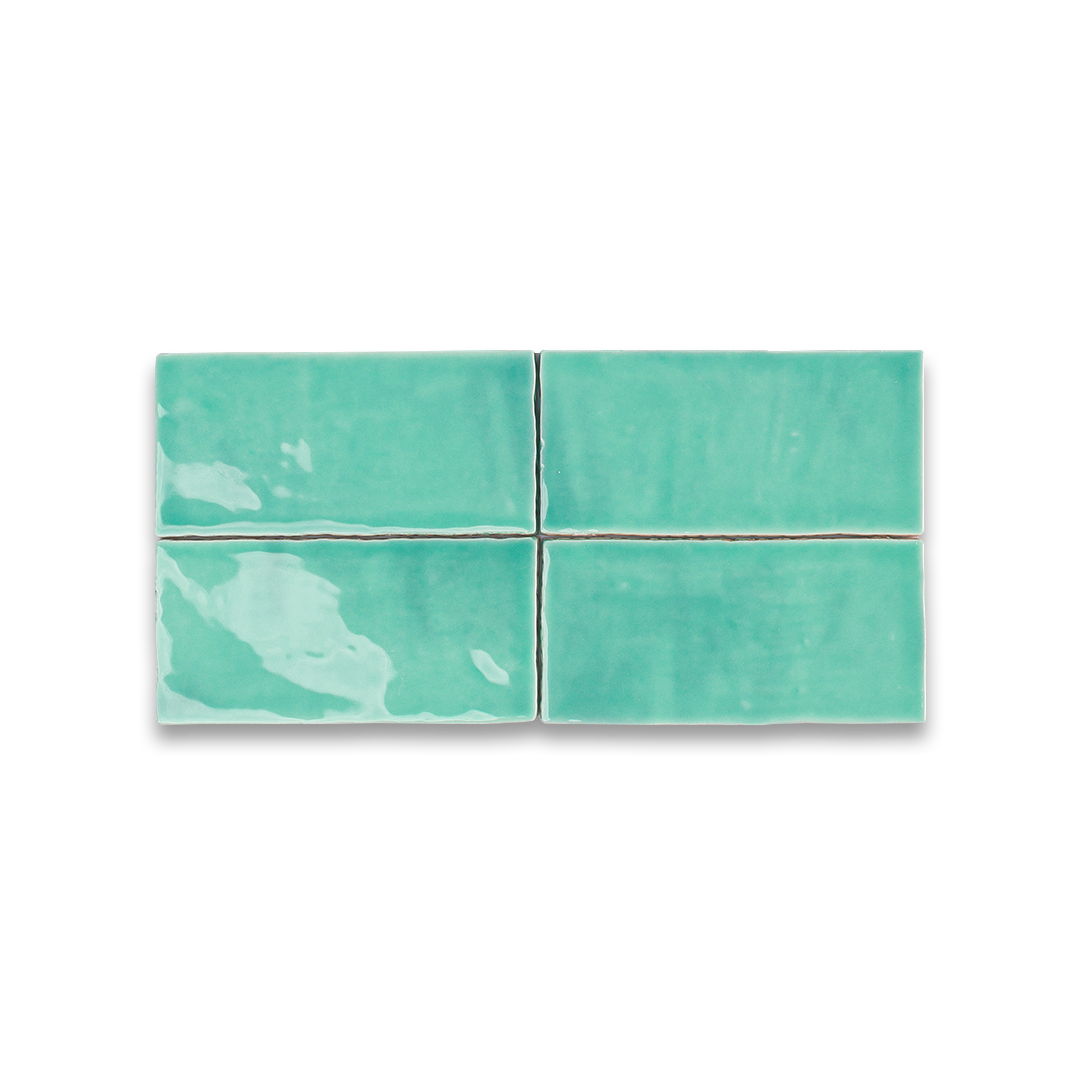 Four teal ceramic tiles arranged in a 2x2 grid on a white background