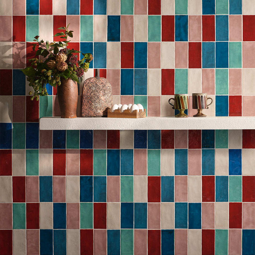Colorful tiled wall with decorative items on a shelf