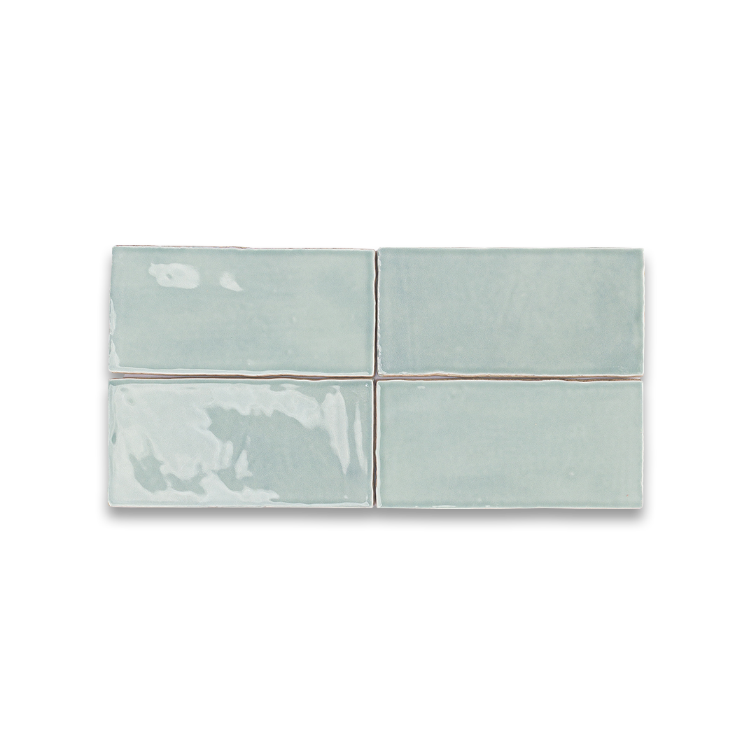 Set of four light blue ceramic tiles on a white background