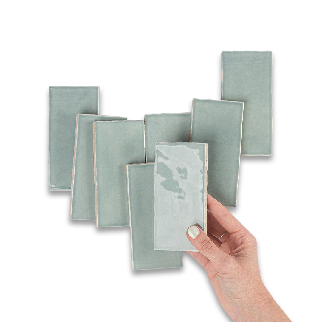 Set of green rectangular cards with a hand holding one card against a white background