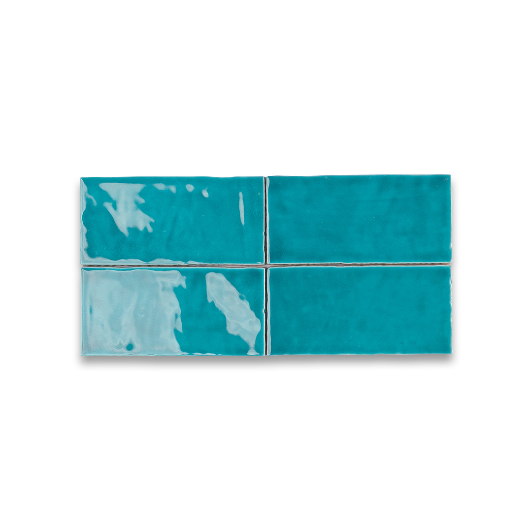 Four turquoise tiles with white patterns on a white background