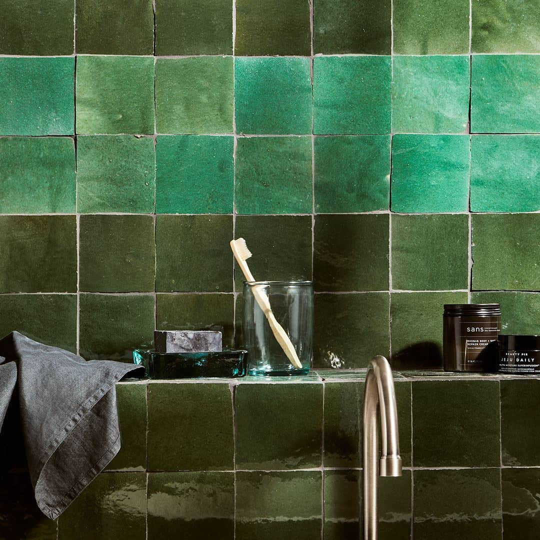 Dark green square tiles arranged in a grid pattern