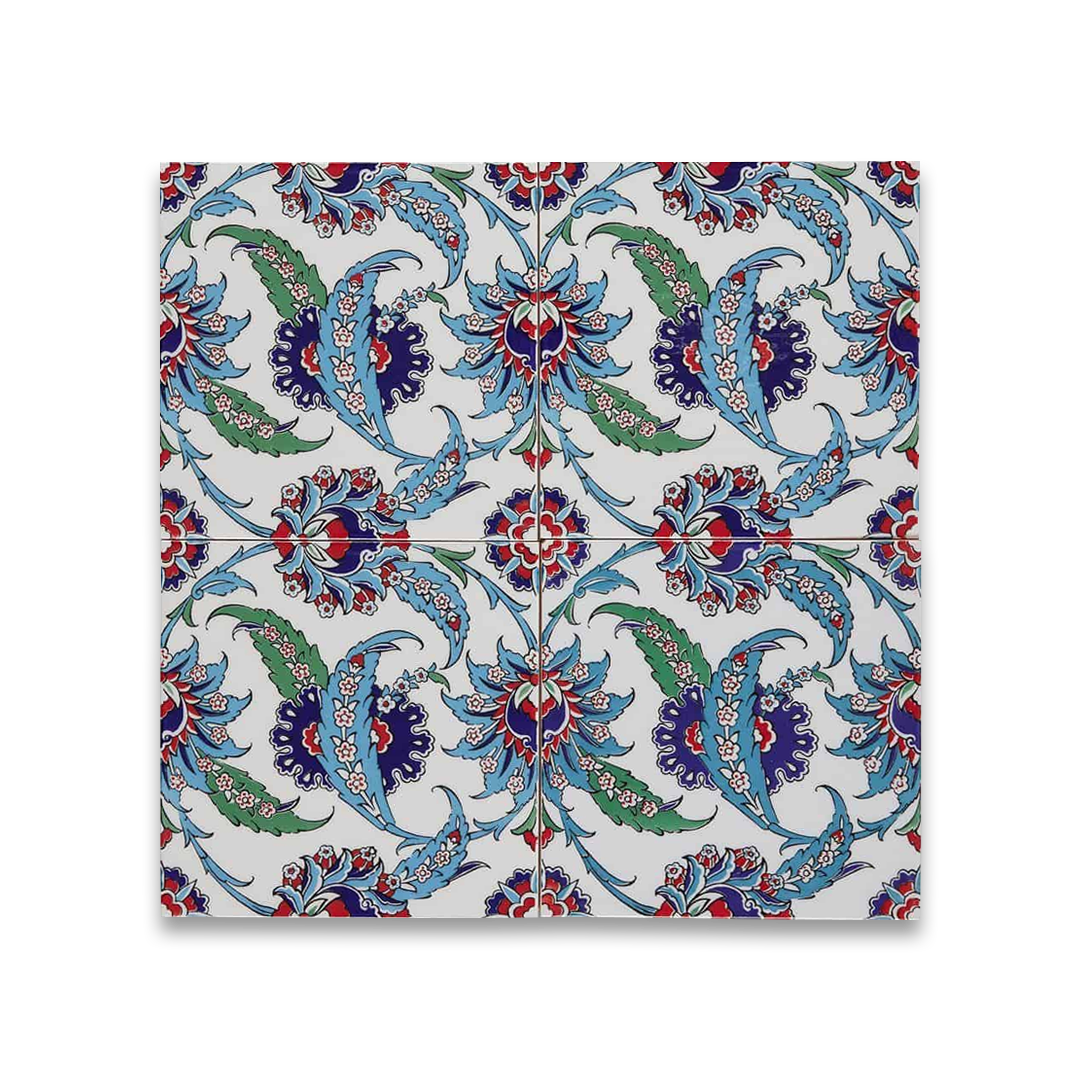 Decorative tile with intricate blue, green, and red floral pattern on a white background