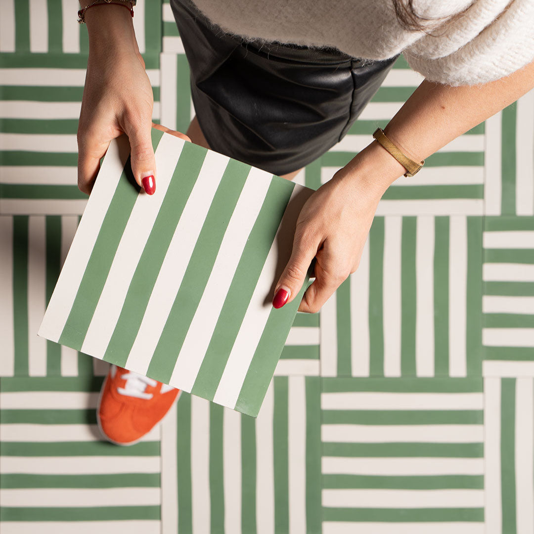 Square cement tile with alternating vertical green and white stripes, creating a clean, minimalist pattern.