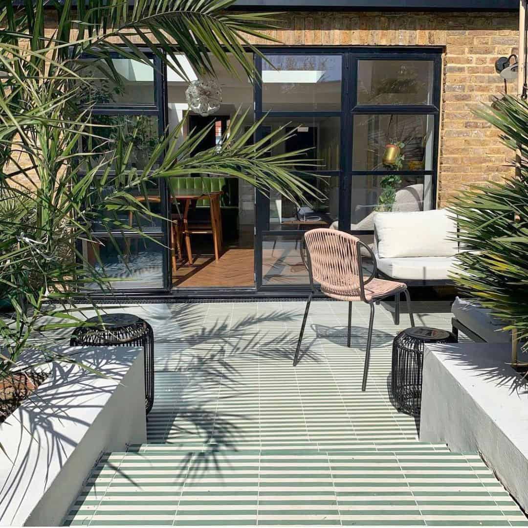 Square cement tile with alternating vertical green and white stripes, creating a clean, minimalist pattern.