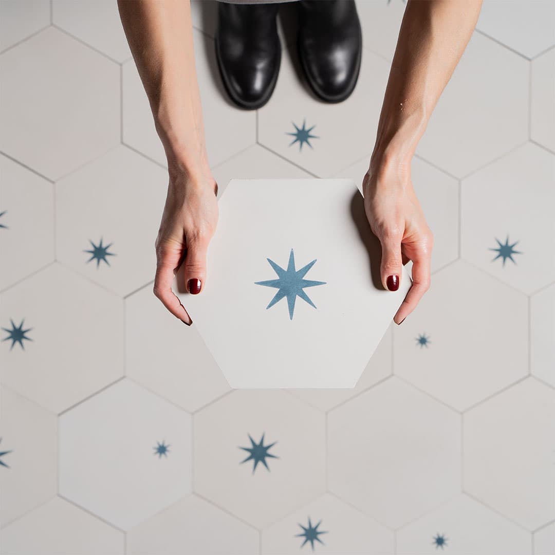 Celestial Hexa Star cement tile featuring a white hexagonal base with teal starburst motifs, ideal for artistic interiors, geometric flooring, and decorative wall applications in modern and vintage spaces.