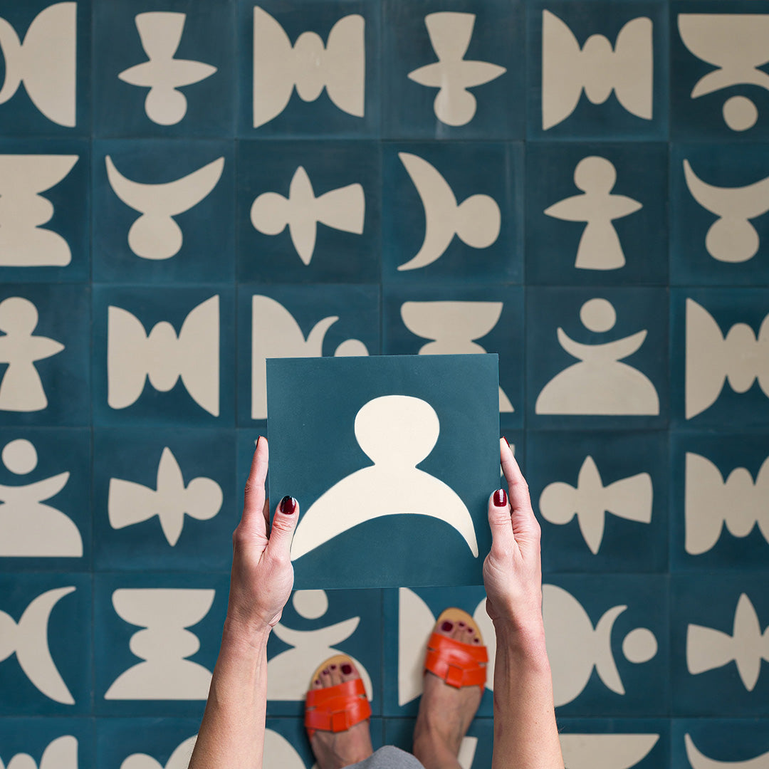 Square blue metro cement tile featuring abstract white geometric shapes with a matte finish, ideal for modern flooring, wall cladding, and contemporary artistic interior design applications.