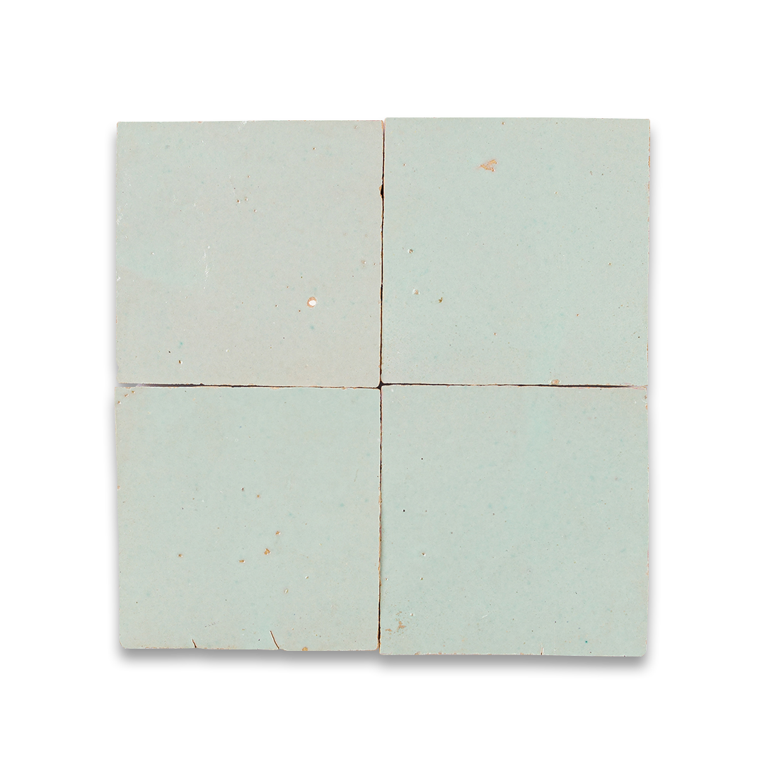 Four square tiles with a light blue-green color on a white background