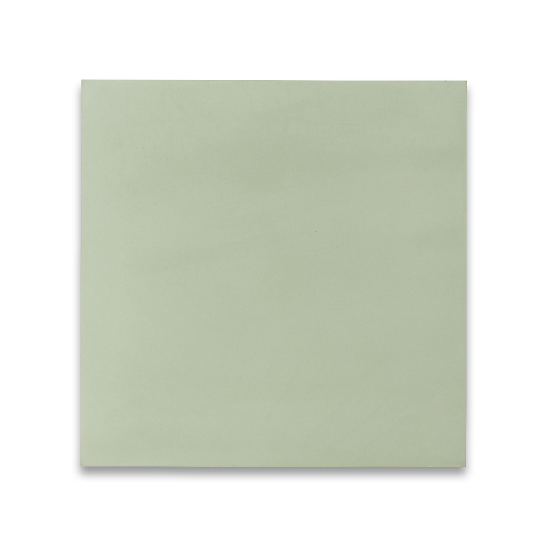 Square cement tile in soft pastel green, minimalist design with smooth surface.