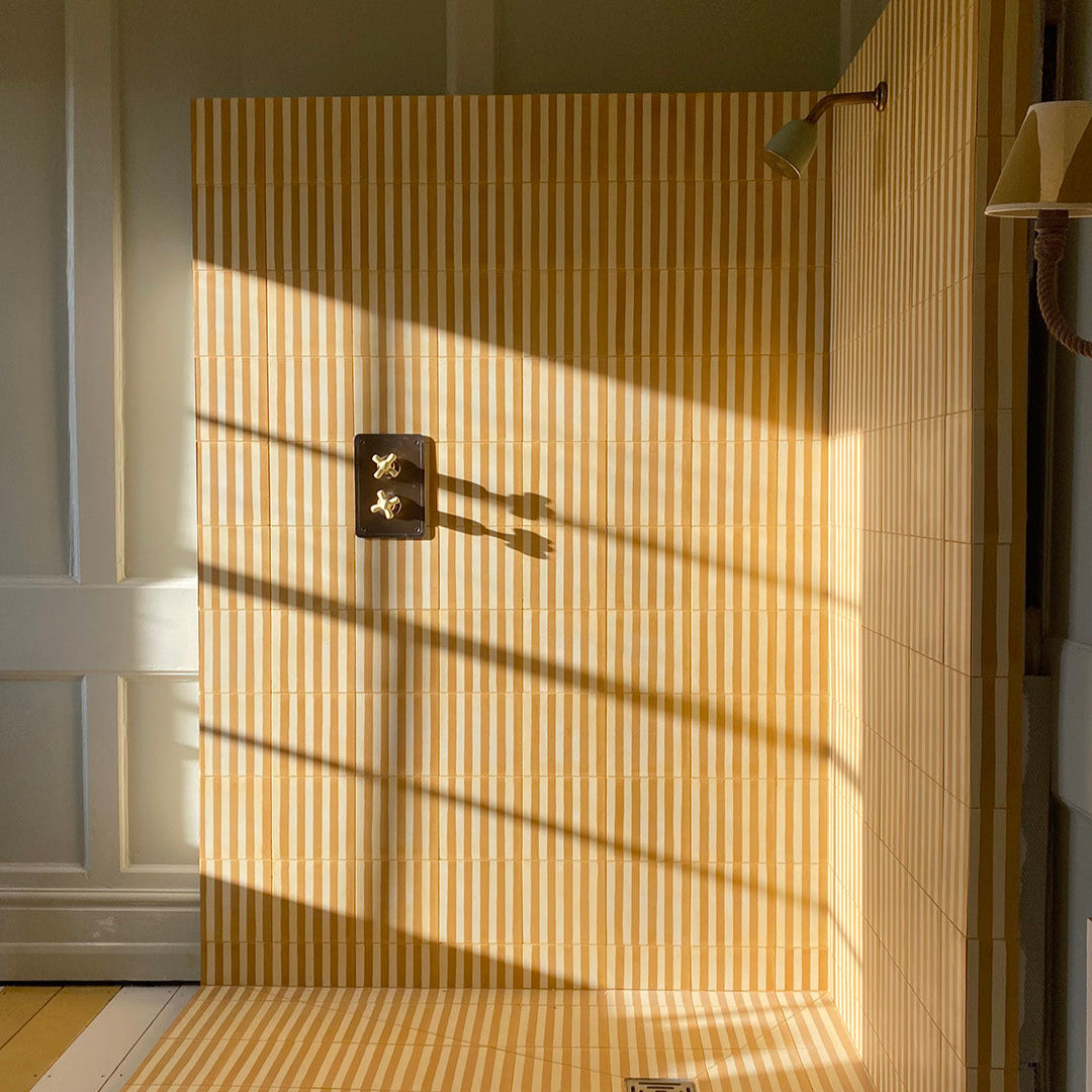 Square cement tile design featuring alternating vertical stripes in mustard yellow and off-white tones with a matte finish, ideal for modern flooring, wall decor, or Mediterranean interiors.