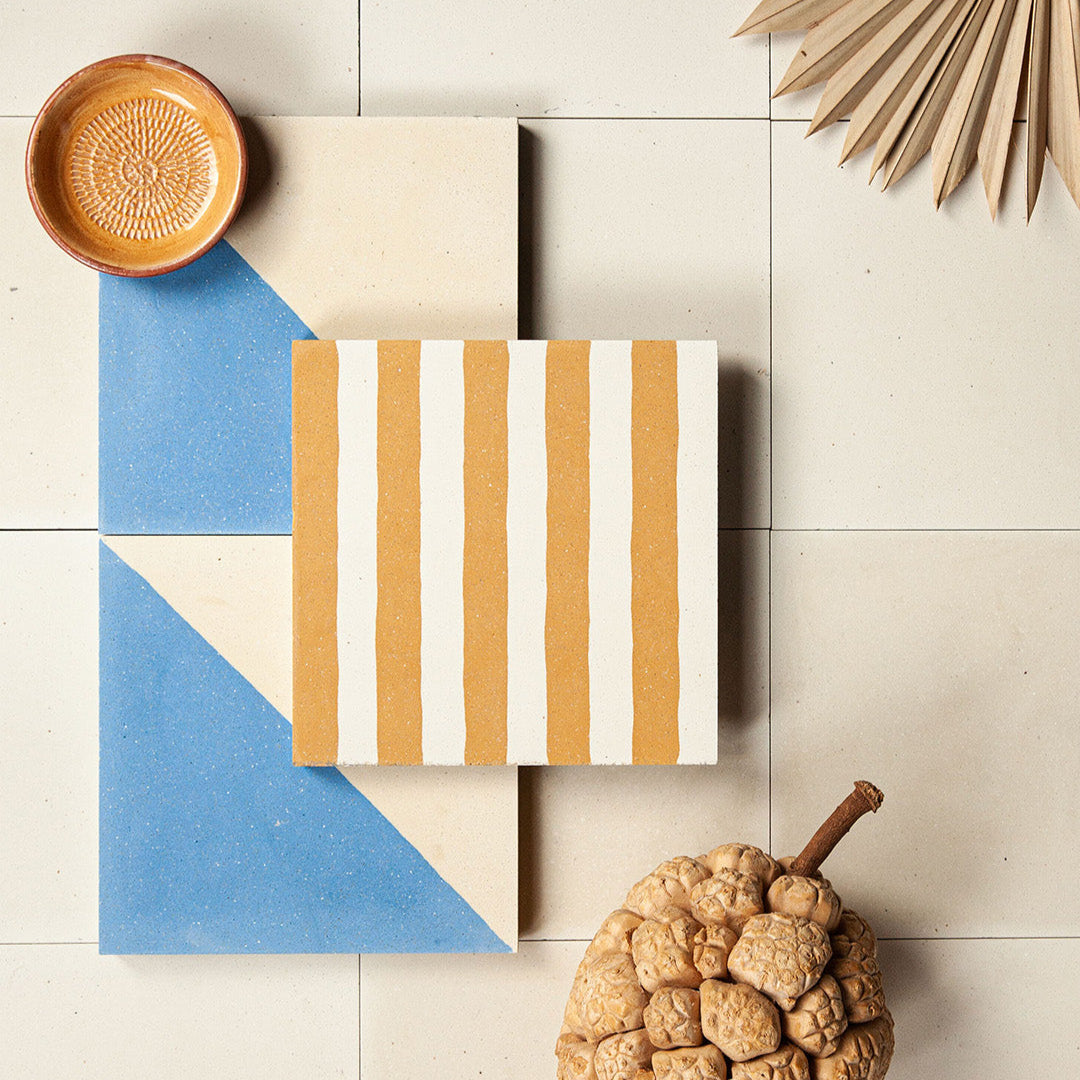 Square cement tile design featuring alternating vertical stripes in mustard yellow and off-white tones with a matte finish, ideal for modern flooring, wall decor, or Mediterranean interiors.