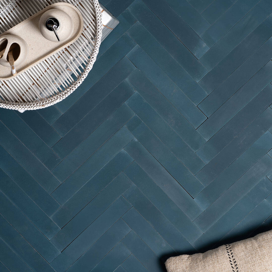 Rectangular blue metro cement tiles arranged in a herringbone pattern with a smooth matte finish, ideal for modern flooring, wall cladding, and contemporary interior design applications.