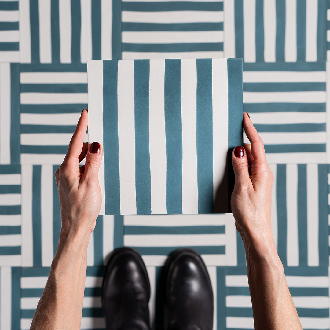 Square blue metro cement tile featuring alternating vertical navy and white stripes with a matte finish, ideal for modern flooring, wall décor, and contemporary interior design applications.