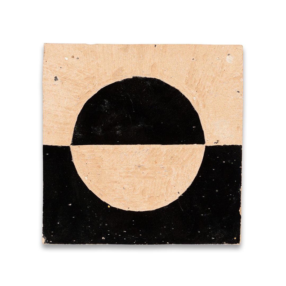 Square tile with black circle on a beige background