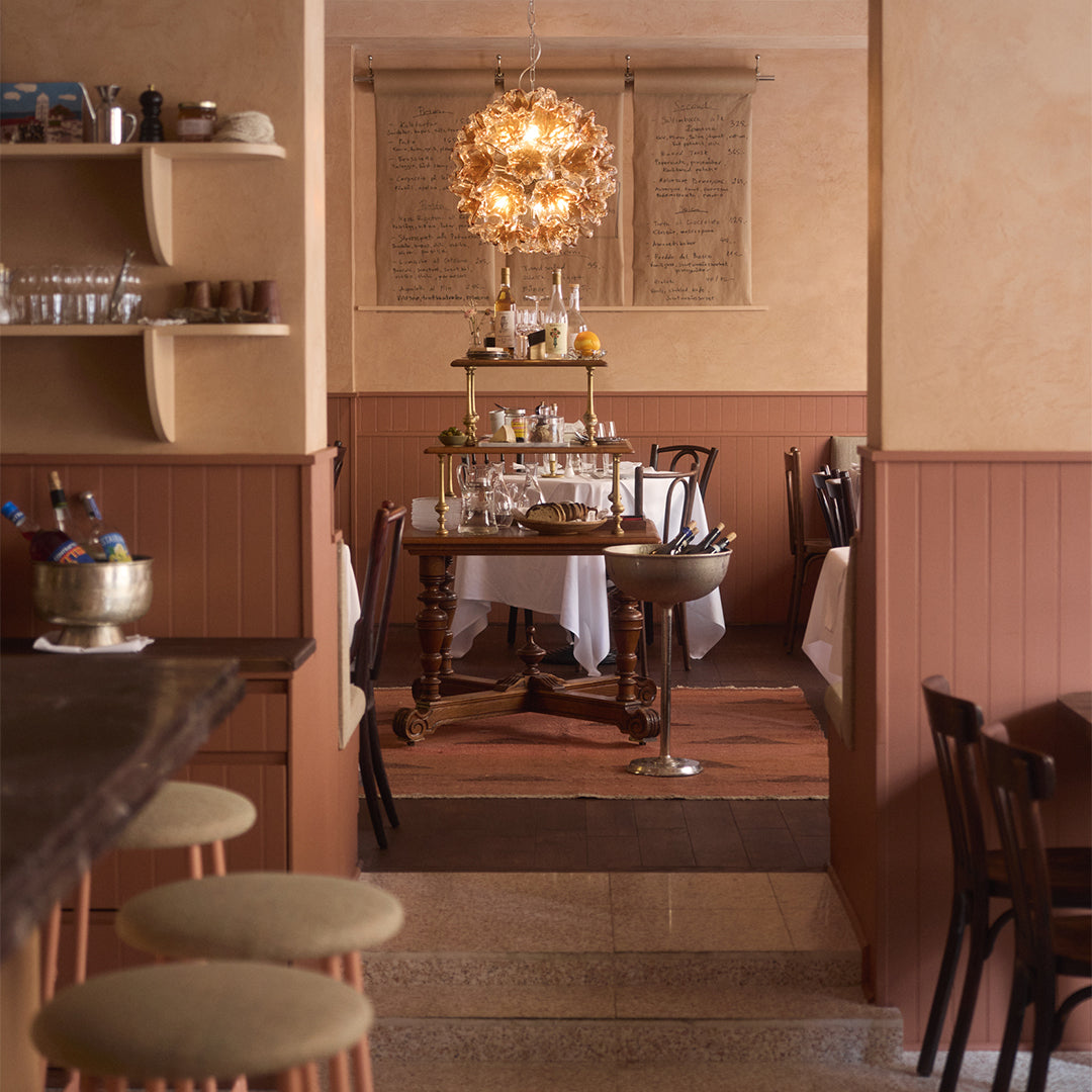 Dining room with wooden table, chairs, and decorative elements.