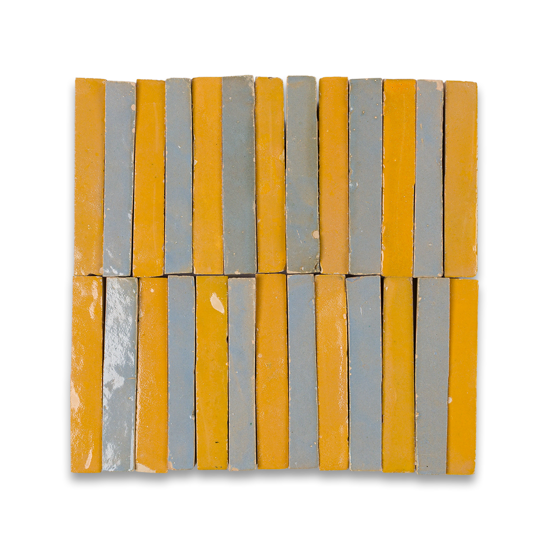 A detailed close-up of a collection of blue and yellow tiles, highlighting their shapes and shades in a stacked arrangement.
