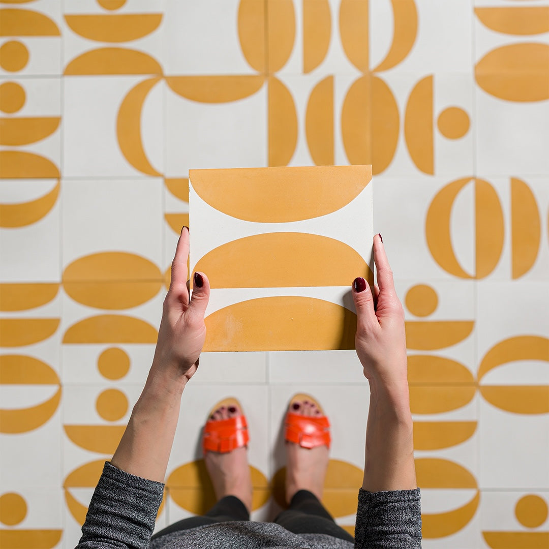 Geometric cement tile design featuring mustard yellow and white abstract shapes with semi-circles and curves, ideal for modern flooring, wall decor, or contemporary Mediterranean interiors.