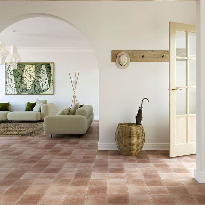 A square cement tile in a warm terracotta color with a smooth matte finish and subtle speckled texture, creating a natural, earthy, and minimalist appearance.