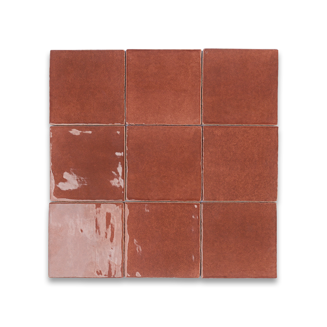 Square ceramic tiles with a terracotta color on a white background