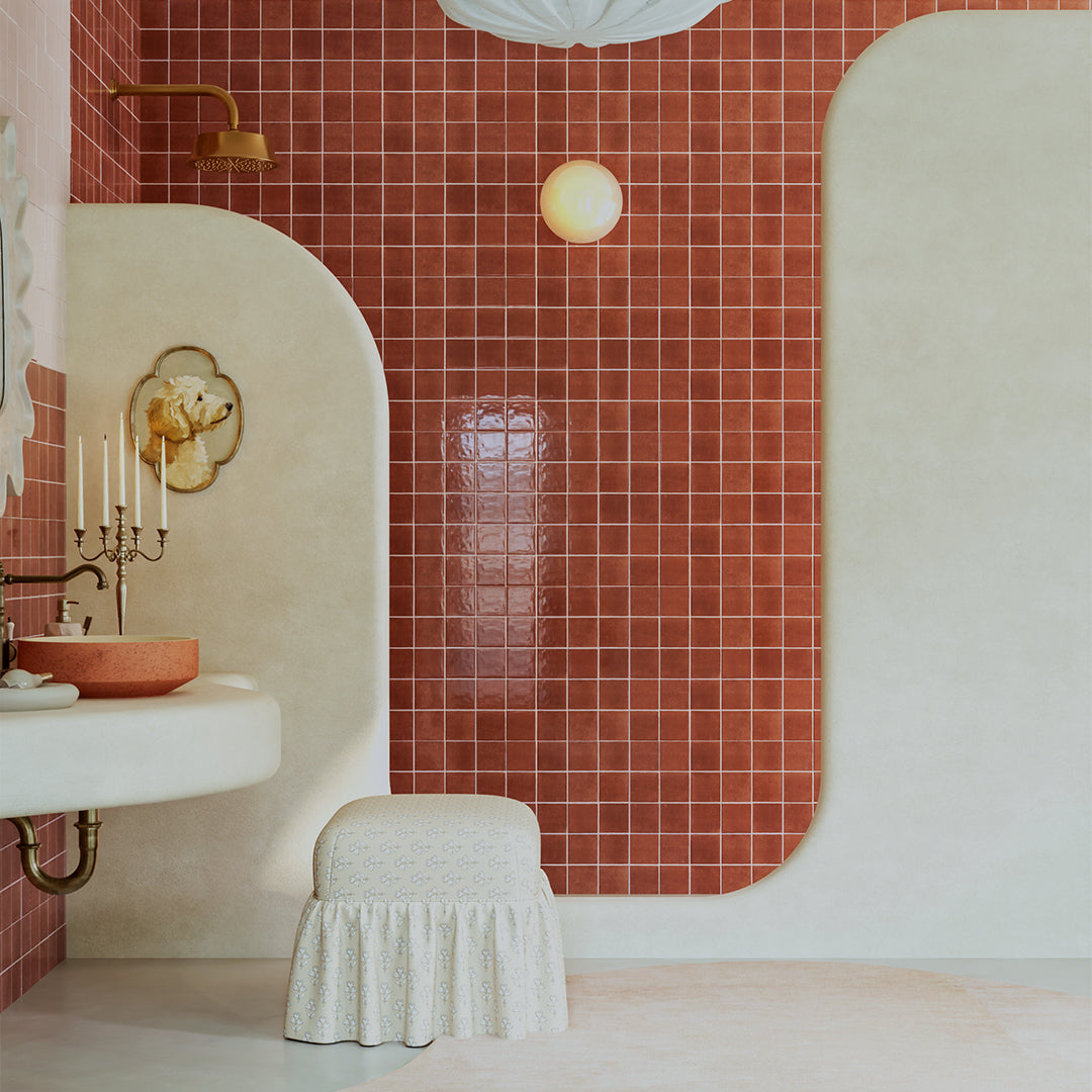 Bathroom with red tiled walls, white sink, and decorative elements.