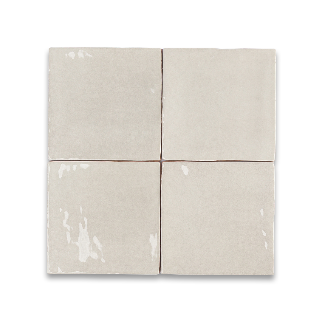 Set of six beige ceramic tiles on a white background