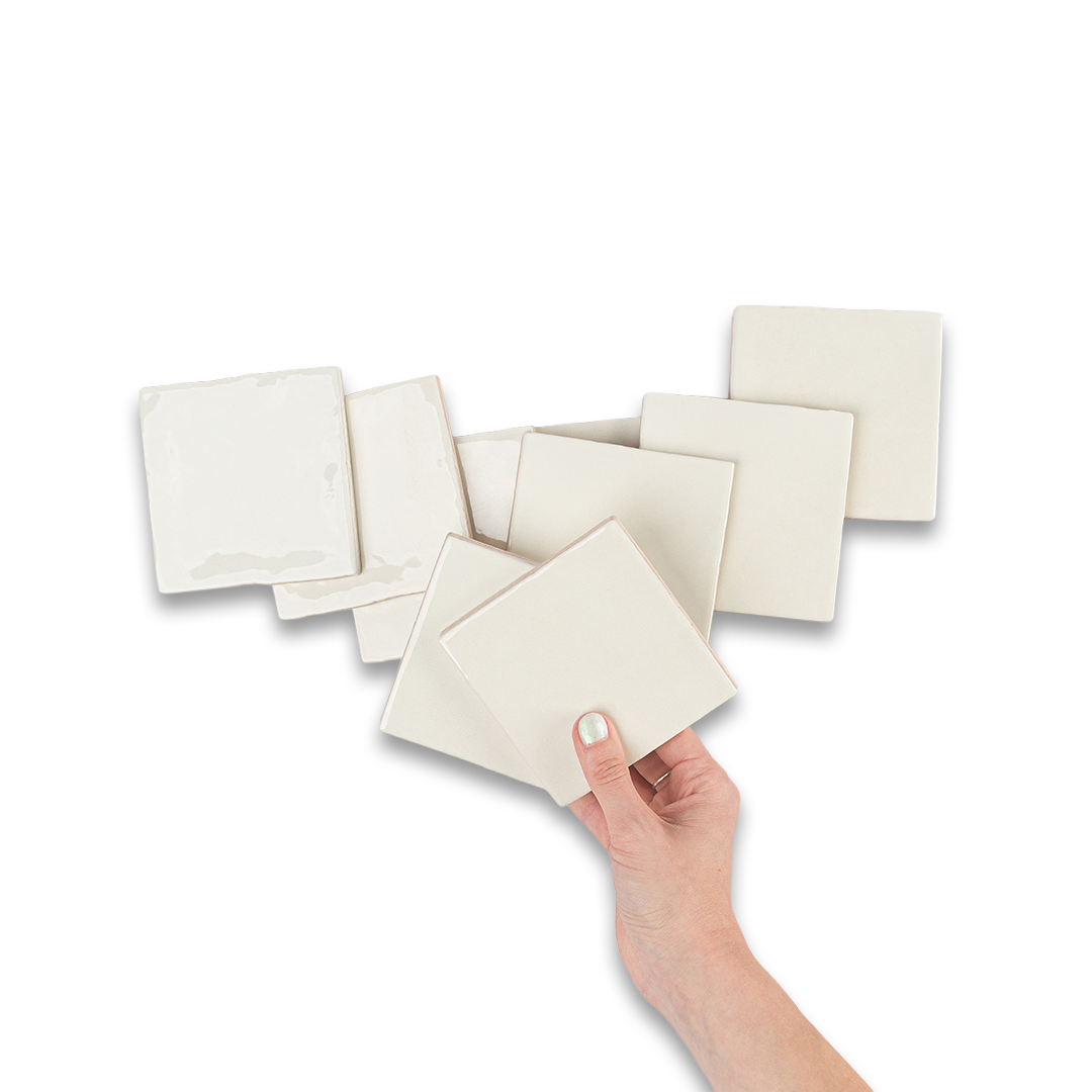 Hand holding a beige square napkin with more napkins on a white background