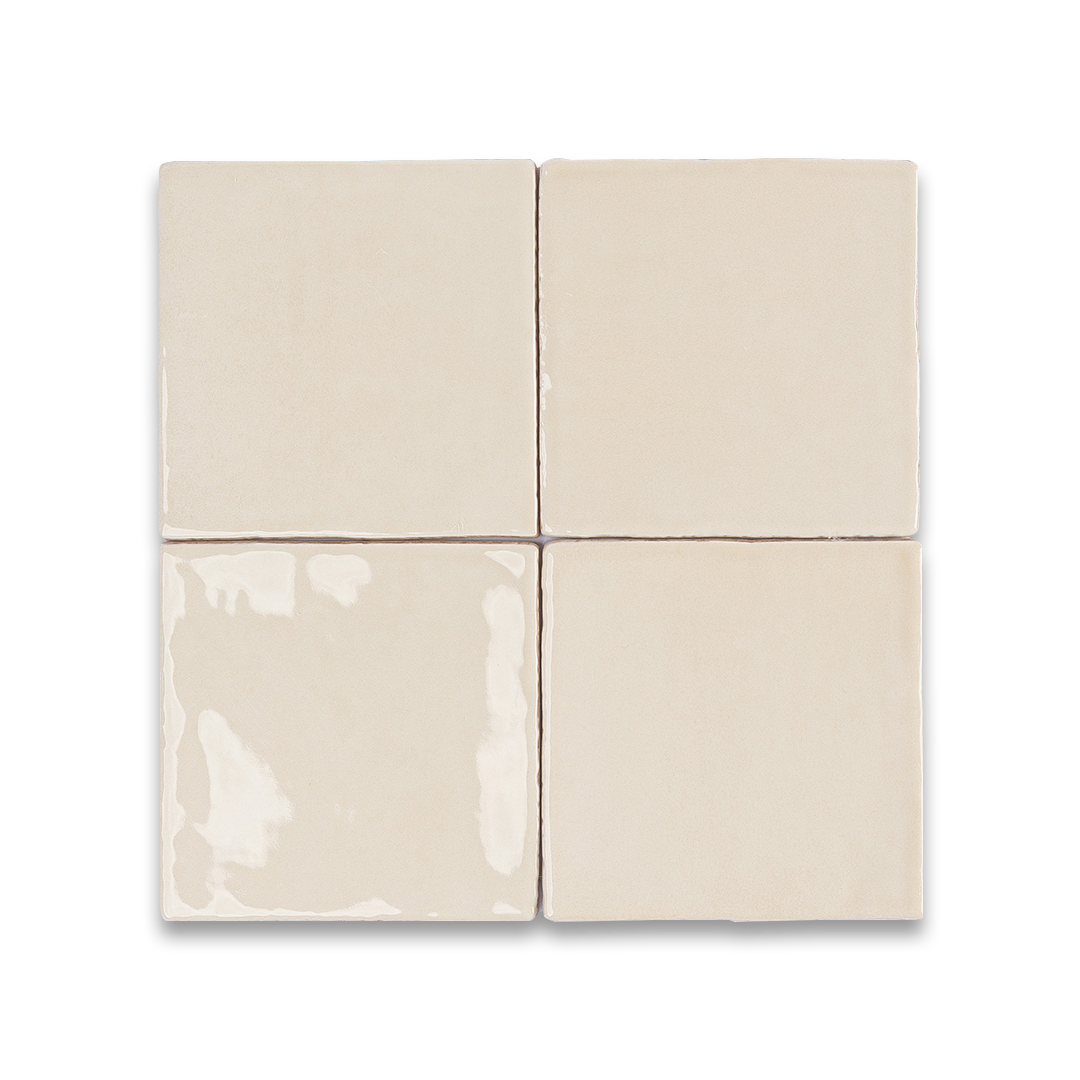 Set of four beige ceramic tiles on a white background