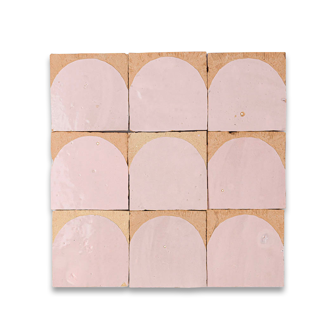 Pink curved tiles arranged in a grid pattern on a cardboard backing.