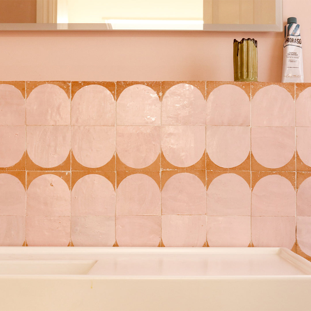 Decorative wall stickers with a geometric pattern applied to a tiled wall.