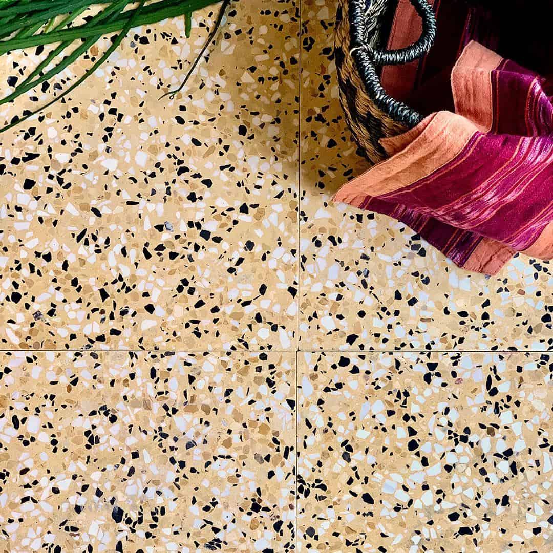 Terrazzo patterned tile with beige, black, and white colors.
