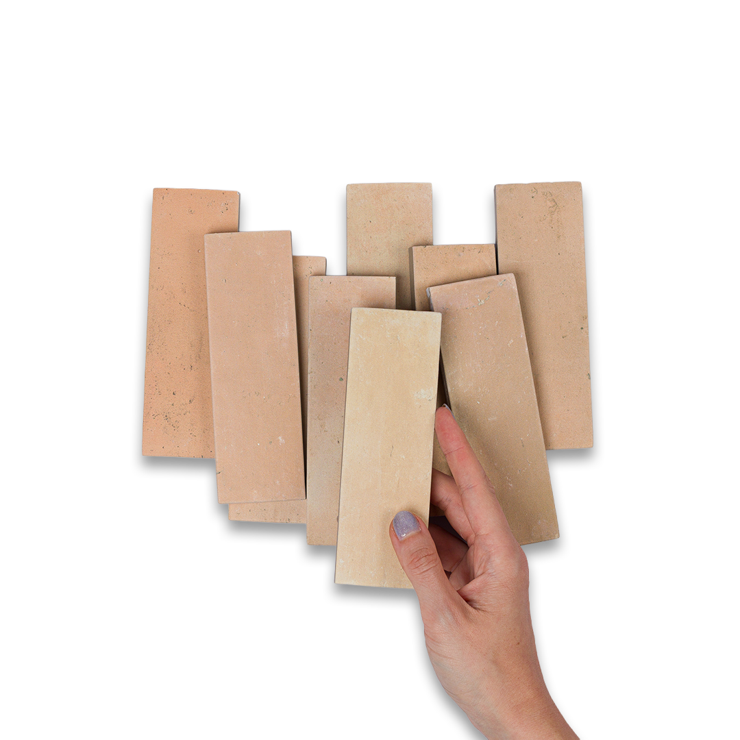 Hand holding a stack of cardboard pieces against a white background